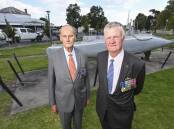 Ex-submariner veterans Michael White and Terry Roach visit the Commander Holbrook Memorial Park on Thursday, 24 hours before their meeting with the owners of the supermarket across the road. Picture by Mark Jesser