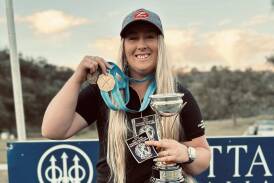 Border clay target shooter Emalene Munro with her medal and trophy after recently placing first at the Oceania Championships in Mudgee, NSW. Picture supplied.