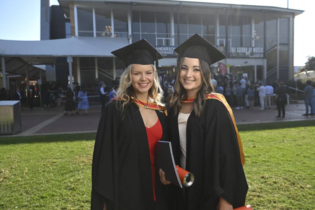 Chloe Turra and Natalie Finlay are celebrating not only their degrees but their new jobs together. Picture by Mark Jesser