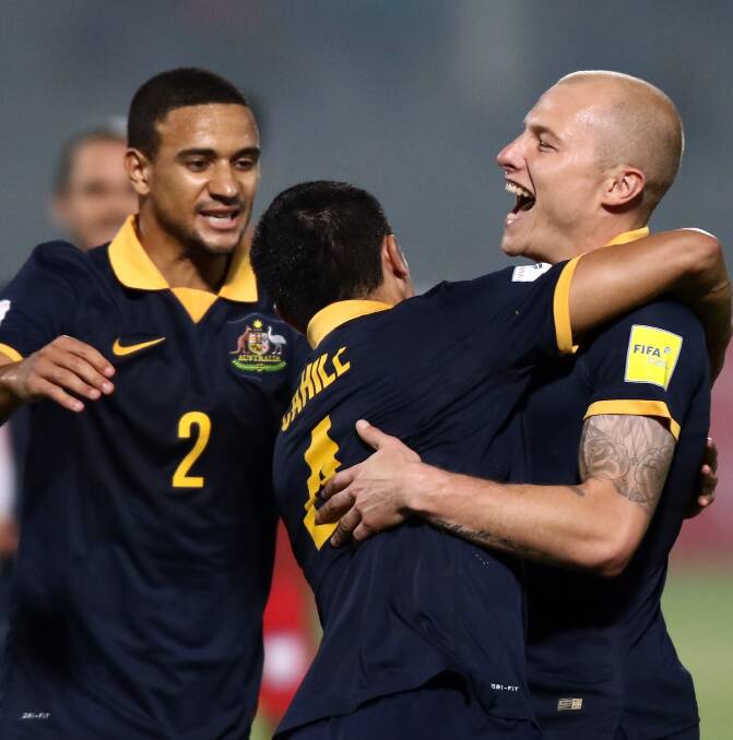 BUZZ: Meredith celebrates with Socceroos legend Tim Cahill and Aaron Mooy. 