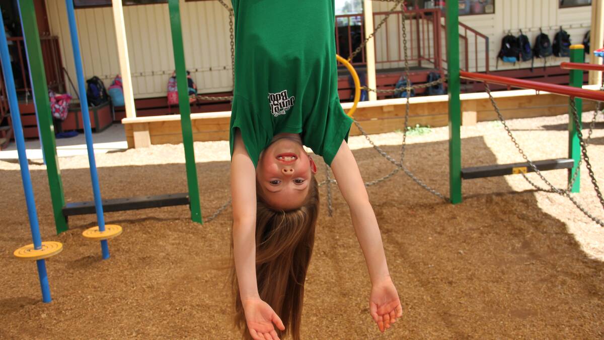HAIR'S OUT: Elizabeth Powles lets her long hair out at school on the monkey bars.