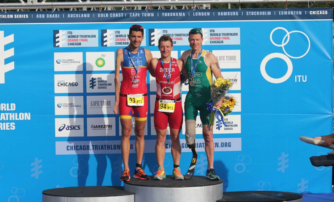 BRONZED UP: Para-triathlete Justin Godfrey stands with the other two medallists from the Chicago Grand Final held in September.