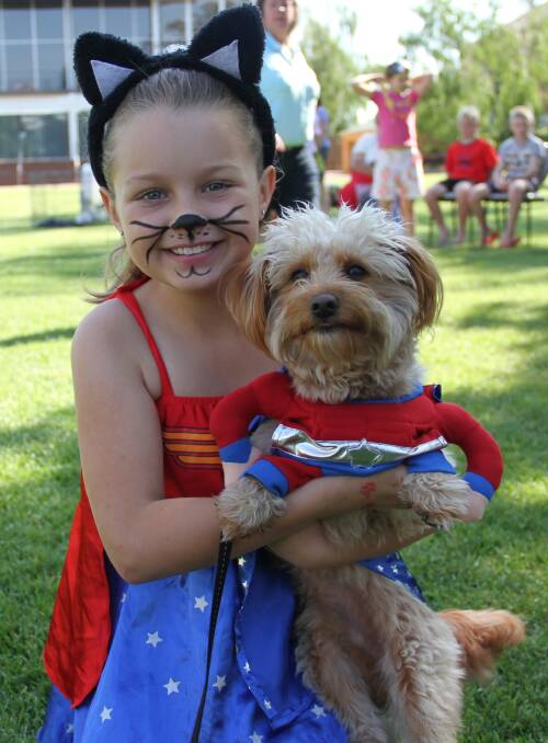 DOGGED UP: Aria Smith, 8, of Albury with one-year-old Milo who won cutest and best dressed dog at Saturday's St Matthew's Fair on the Square. Picture: DAVIS HARRIGAN