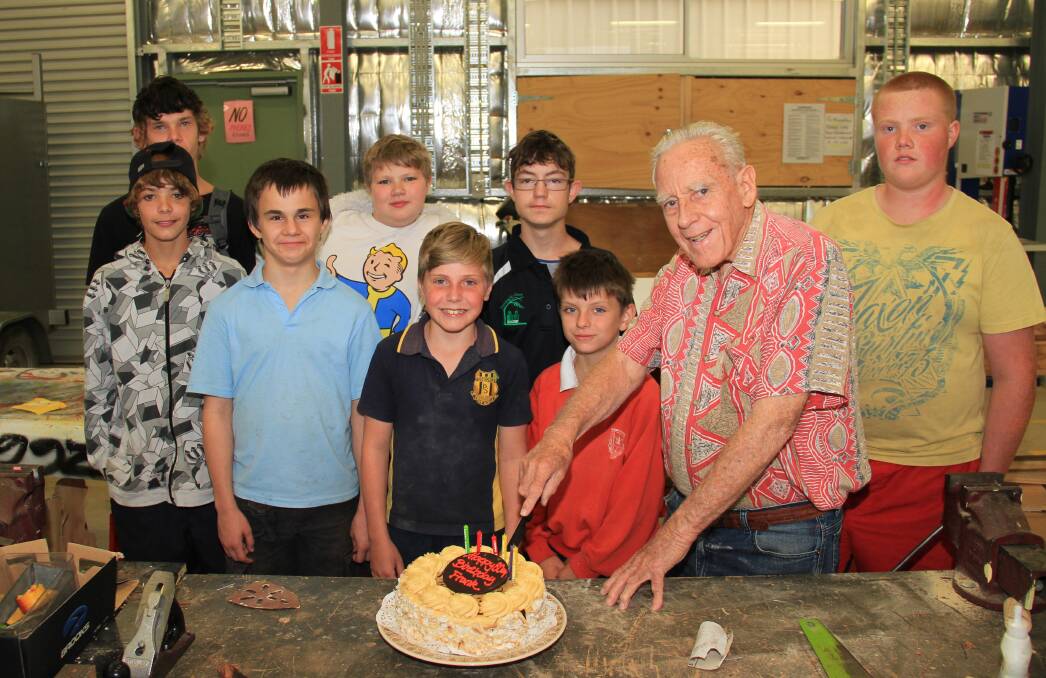 WORK: Frank Lange celebrated his 80th birthday at Kandeer School last week with several students he has been doing metal and woodwork with. Picture: DAVIS HARRIGAN