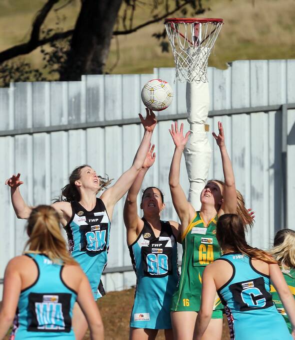 OUT OF REACH: Sarah Meredith, Rhi Dolahenty and the Hoppers Jess Fisher-Curnow stretch for the ball during the clash at the Lavington Sports Oval on Saturday. Picture: JOHN RUSSELL