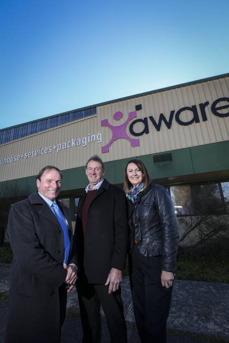 NEW ERA: Community College chief executive Rodney Wangman, Aware chairman Vin O'Neill and board member Alison Reed embrace the merger. Picture: JAMES WILTSHIRE