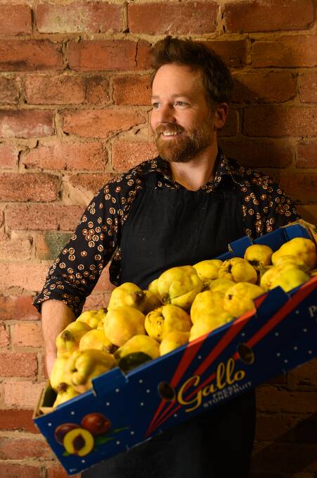 THINKING INSIDE THE BOX: Saint Monday co-owner Chris McGorlick takes delivery of a box of quinces from a customer with an abundant supply. Pictures: MARK JESSER
