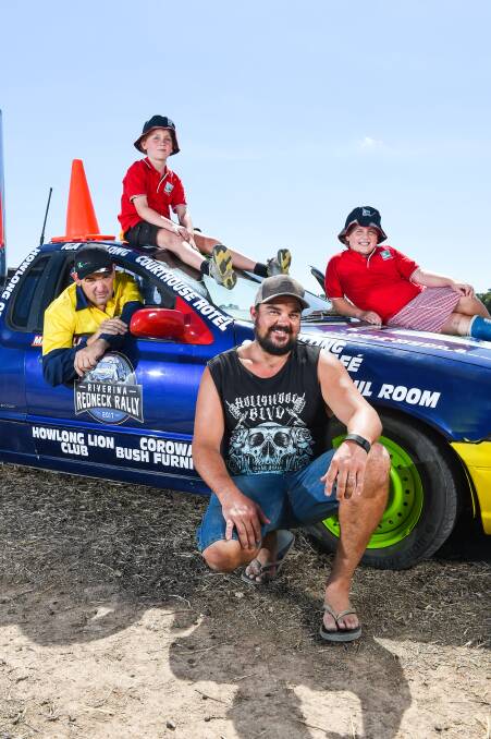 FAB FOUR: Howlong man Brad Ewing in the driver's seat with his brother-in-law Darren Crutch and Ella, 9, and Rory McMahon, 8, ahead of the Riverina Redneck Rally.