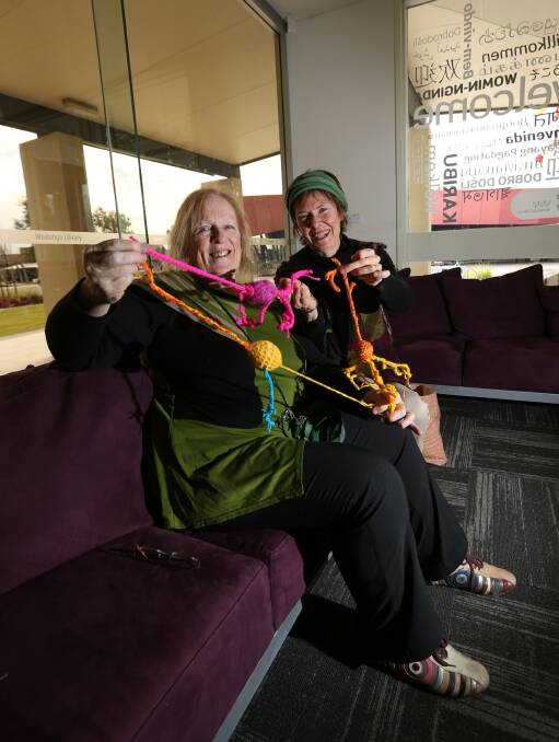 STITCHED UP: Textile artist Abi Thompson and CSU lecturer Therese Schmid try their hand at knitting neurons as part of a community art project. Picture: JAMES WILTSHIRE 