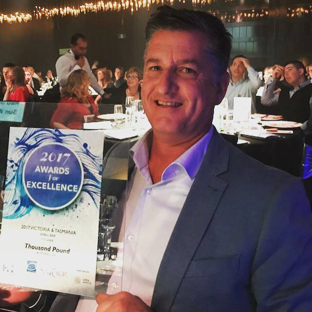 HERE'S CHEERS: Thousand Pound Wine Bar & Store developer Denis Lucey accepts the Savour Australia Best Small Bar award in Melbourne on Monday night.