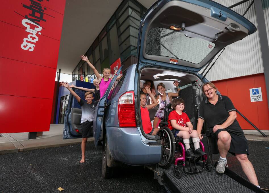 CRUISE CONTROL: Natalie Dyball and Lillian, 7, collect the car with Flying Fruit Fly Circus members cheering them on. Picture: JAMES WILTSHIRE