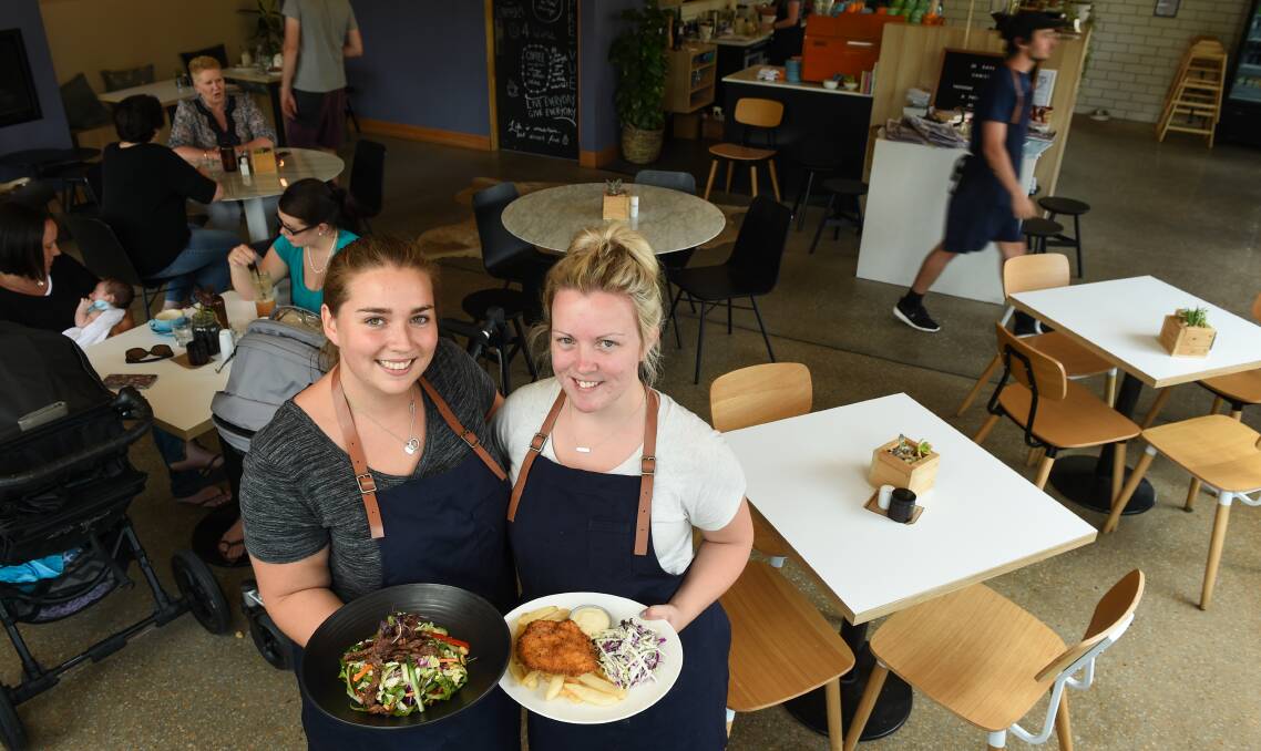 ETHICAL TRADE: Wangaratta eatery Cafe The PreVue supports ethically-farmed food in the North East as does office manager Emilie Brown with a Thai beef salad and barista Kellie Hamilton with a herby schnitzel. Picture: MARK JESSER