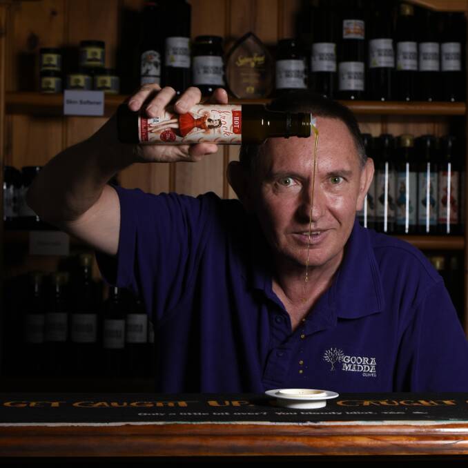 TOP DROP: Gooramadda Olives owner Rob Whyte focuses on the Hot Frock product, which comprises blood orange, chilli, seasonings and olive oil. Other offerings include Exotic, Little Black, Beach and Vintage. Picture: SIMON BAYLISS
