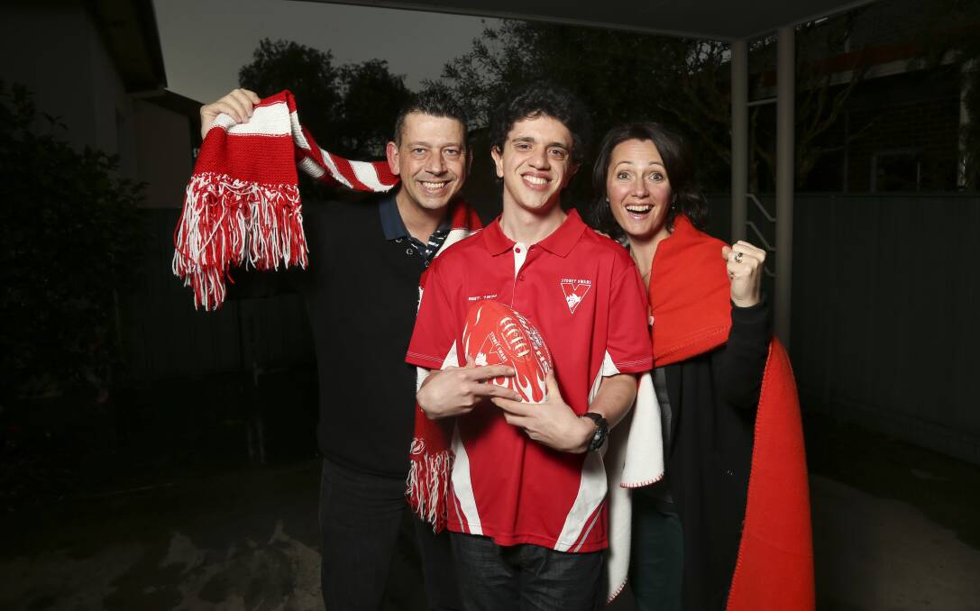FAN BASE: Aaron Powell with his parents David and Melisa Powell will go to their first AFL grand final on Saturday. Picture: ELENOR TEDENBORG