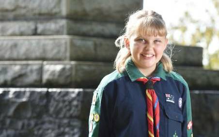 Scouts member Gemma Fletcher, 11, prepares to stand guard over the Burnie cenotaph on the night before Anzac Day. Picture: Brodie Weeding