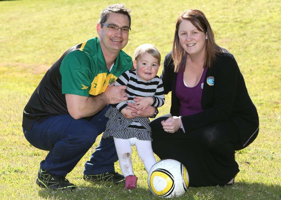 FAMILY MAN: John, Scarlett and Shannon Ritchie have a kick around, but another one will soon be joining them. Picture: ELENOR TEDENBORG
