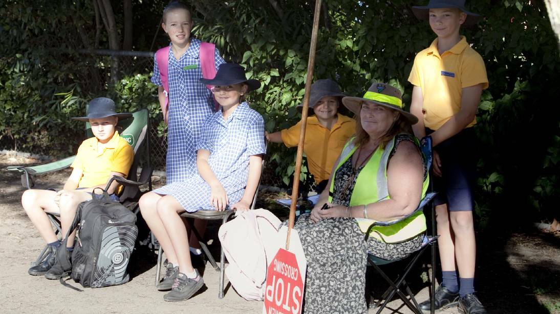 SADLY MISSED: The late Pat McKinnon (second from right) in the place she loved, helping Holbrook Public School students navigate the perils of Albury Road.