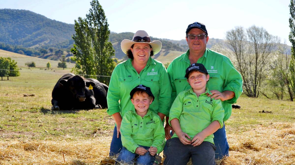SUCCESS STORY: Tara and David Brewer with their sons Henry and Austin at the Tallangatta Valley property. Their black simmentals are known for their quiet, easy-care nature. Picture: EMMA MOYLE