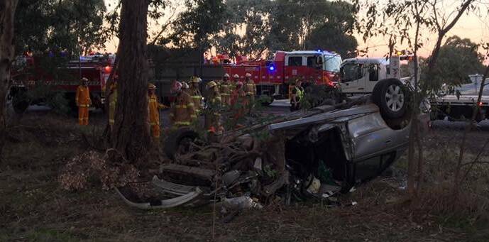 SERIOUS CRASH: Emergency crews worked together this evening to free the driver of this vehicle, following a rollover on the Old Hume Highway, between Wangaratta and Glenrowan. Picture: PAUL MCCULLY