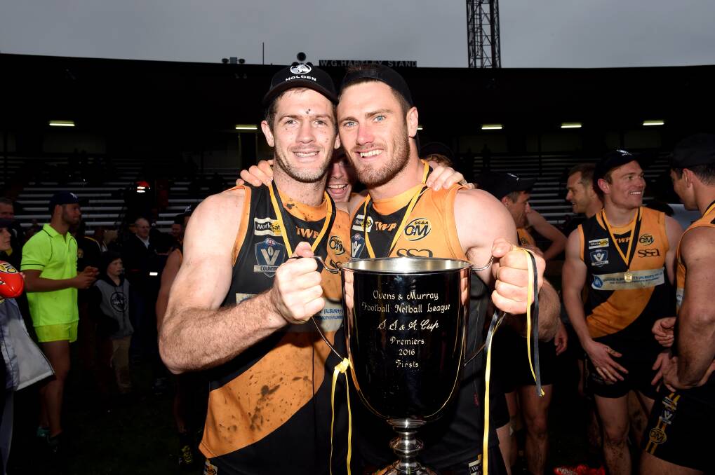 THAT'S HOW YOU HOLD THE CUP: Albury's Shaun Daly and Brayden O'Hara receiving accolades while holding the premiership cup after Sunday's win. Picture: MARK JESSER