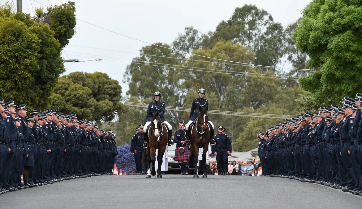 GUARD OF HONOUR: Wangaratta, Horsham and police command officers along White Street after Thursday's funeral. Pictures: MARK JESSER