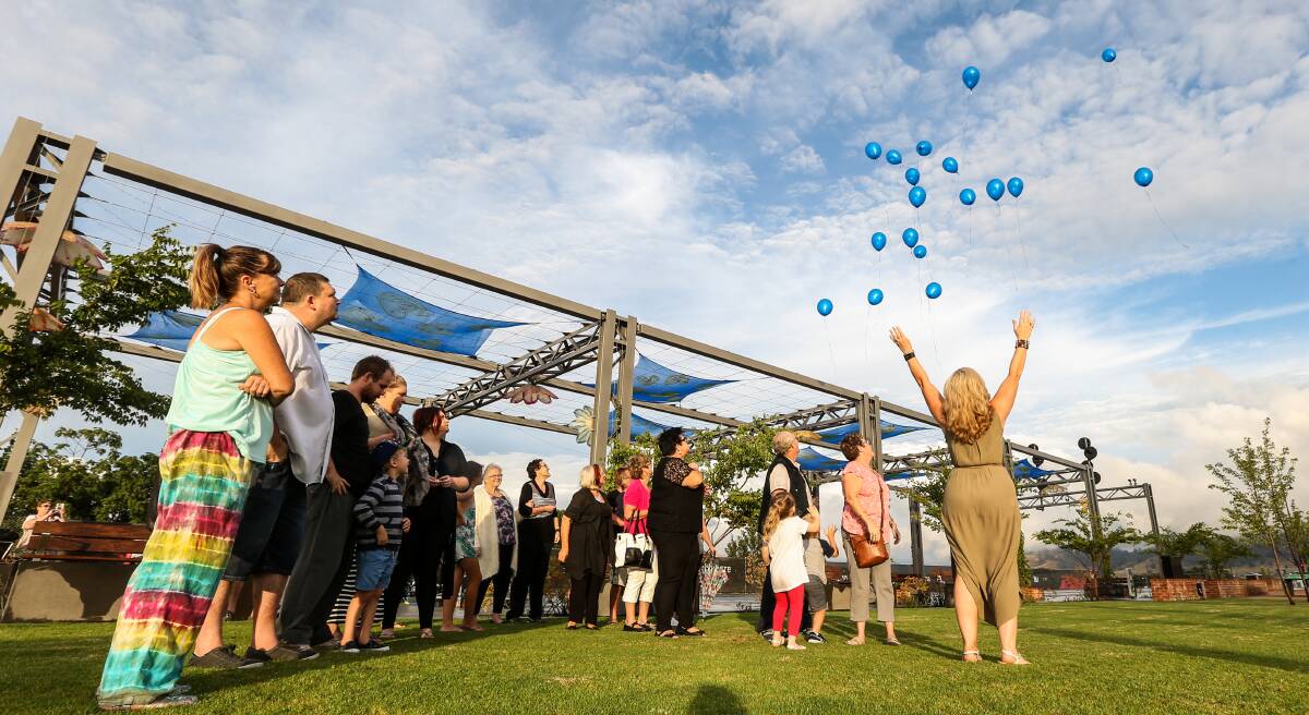 FOR KAREN: Twenty balloons were released into the air during an emotional vigil held at Wodonga's Junction Place as rain cleared on Friday evening. Pictures: JAMES WILTSHIRE