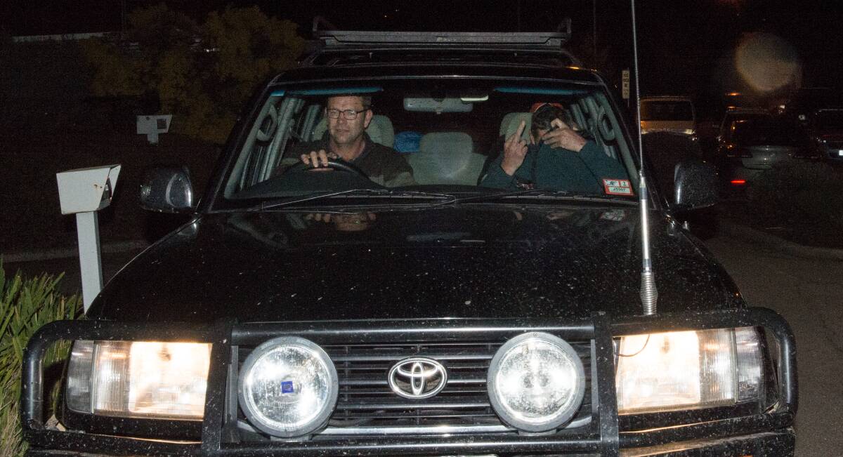 ONE FINGER SALUTE: Ken Tromp drives brother Mark, who had a message for waiting media on his way out of Wangaratta police station.