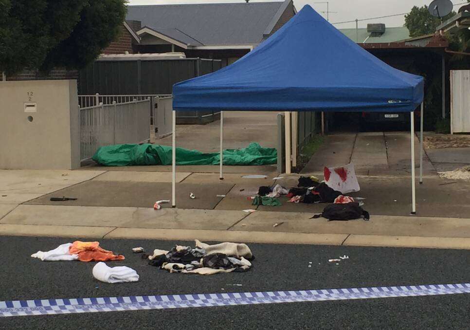 HORROR SCENE: A bloodied pillow and clothing remained out the front of a White Street home in Wangaratta on Saturday in the aftermath of a brawl between armed men. Picture: SHANA MORGAN