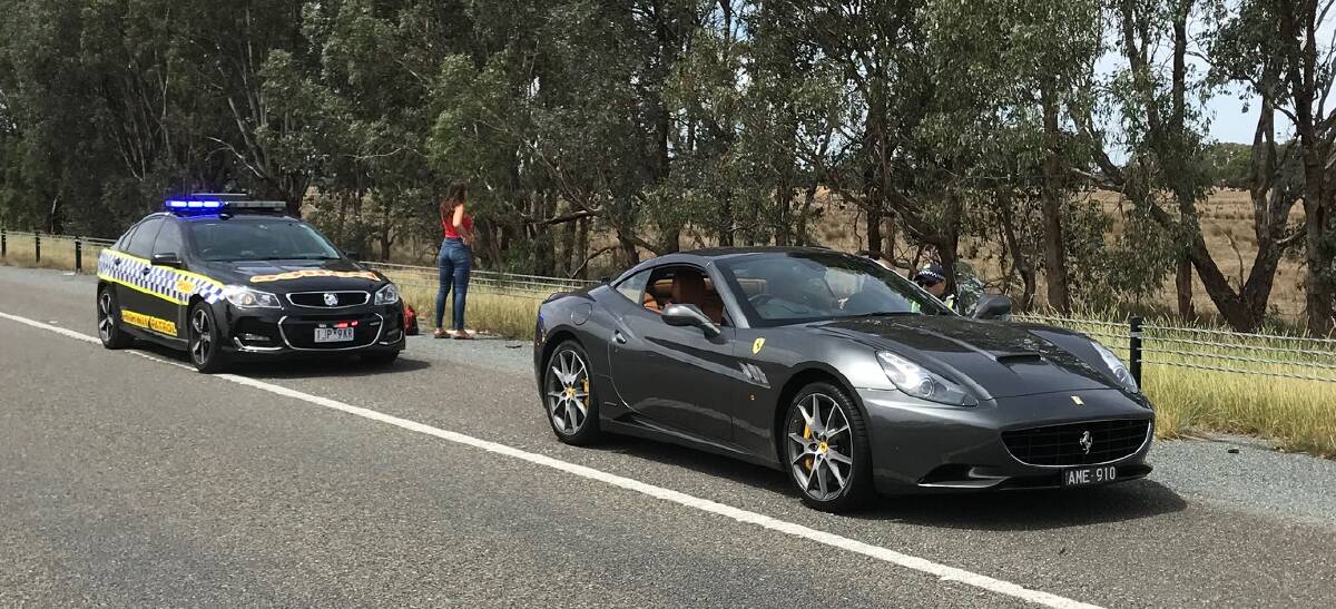 DOUBLE THE SPEED: The black Ferrari pulled over by Wangaratta Highway Patrol.