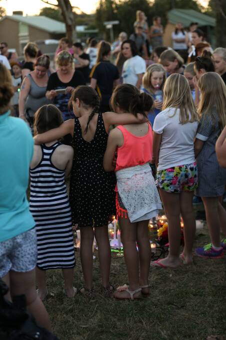 UNITED IN GRIEF: Children were among the hundreds of mourners who attended a candlelight vigil on Tuesday in Zoe's honour. Picture: JAMES WILTSHIRE