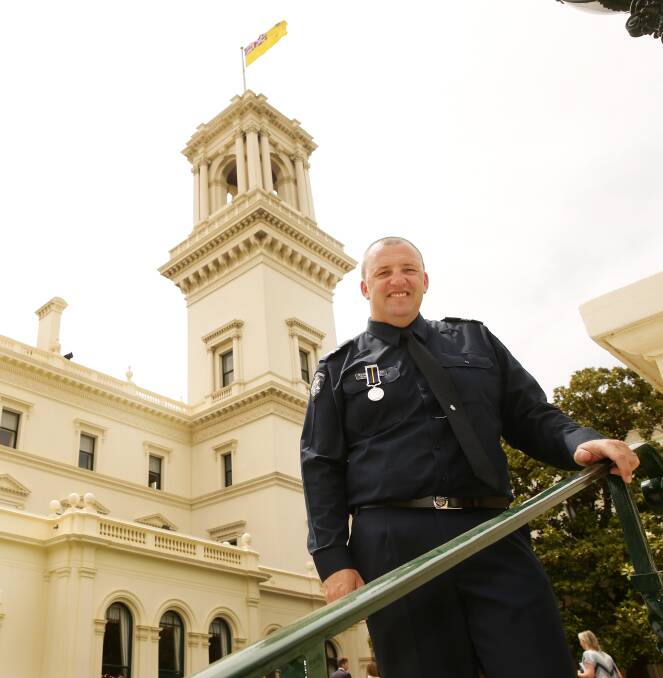 HERO COP: Wangaratta Sergeant Scott Bradley attended the awards ceremony on Wednesday where he was presented with his medal by Governor of Victoria Linda Dessau. Picture: NORM OORLOFF