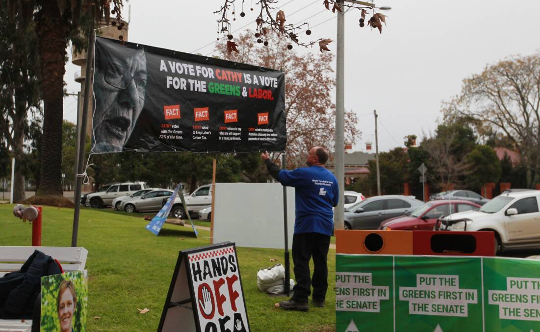 SIGNS STAY: Greg Mirabella with the controversial signs at Wangaratta GOTAFE. Picture: SHANA MORGAN