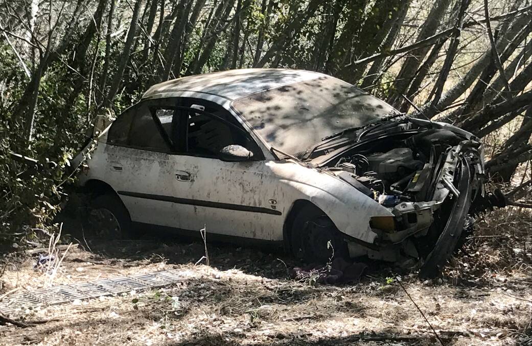 FATAL CRASH: Police are investigating what occurred with this white Holden Commodore sedan on Kiewa East Road. Pictures: SHANA MORGAN