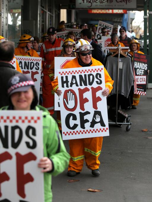 HANDS OFF: Volunteers marched at a Warrnambool rally, warning the disagreement could mean the end of office for Premier Daniel Andrews. Picture: ROB GUNSTONE