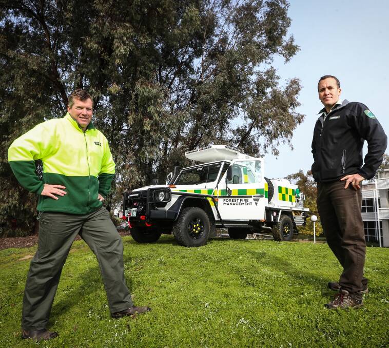 SAFETY: DELWP's Cameron McDonald and Aaron Kennedy with the G-wagon. Picture: JAMES WILTSHIRE