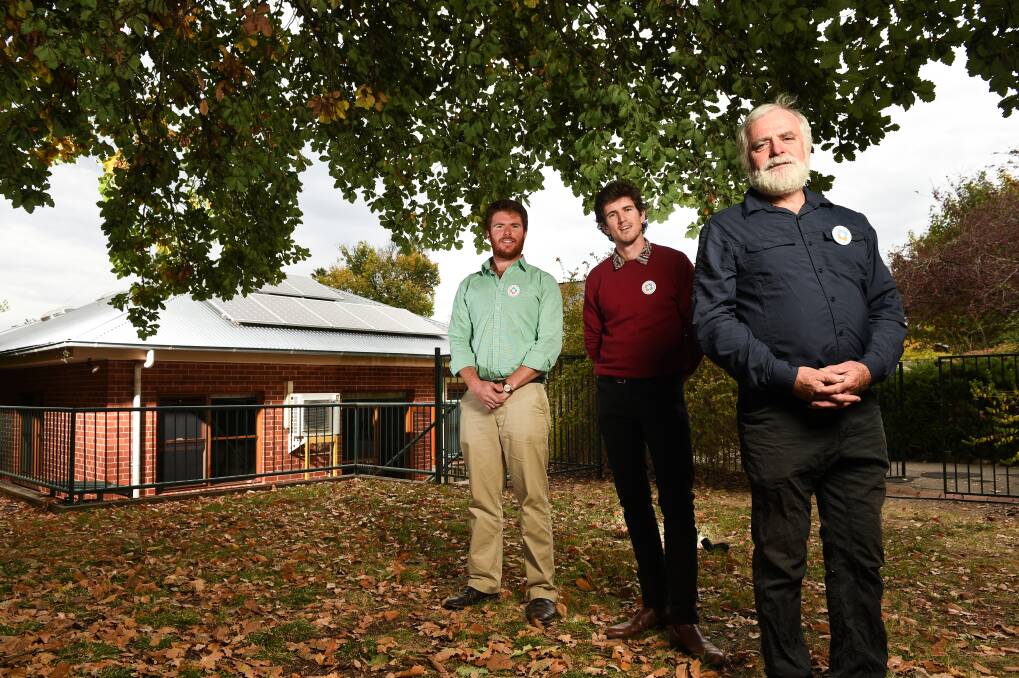 TEAM SOLAR: Matt Grogan, Ben McGowan and Denis Ginnivan at the solar-powered Yackandandah Public Hall. Picture: MARK JESSER
