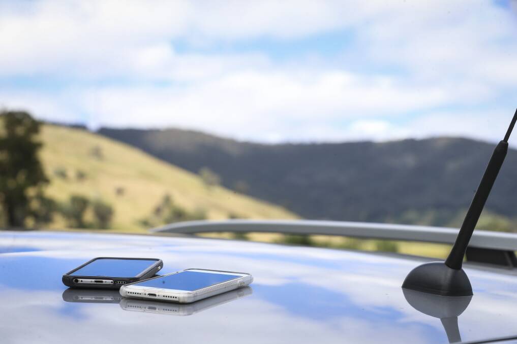 PHONE BATTLE: The Telstra and Optus mobiles on their adventure along Beechworth-Wodonga Road. Pictures: JAMES WILTSHIRE
