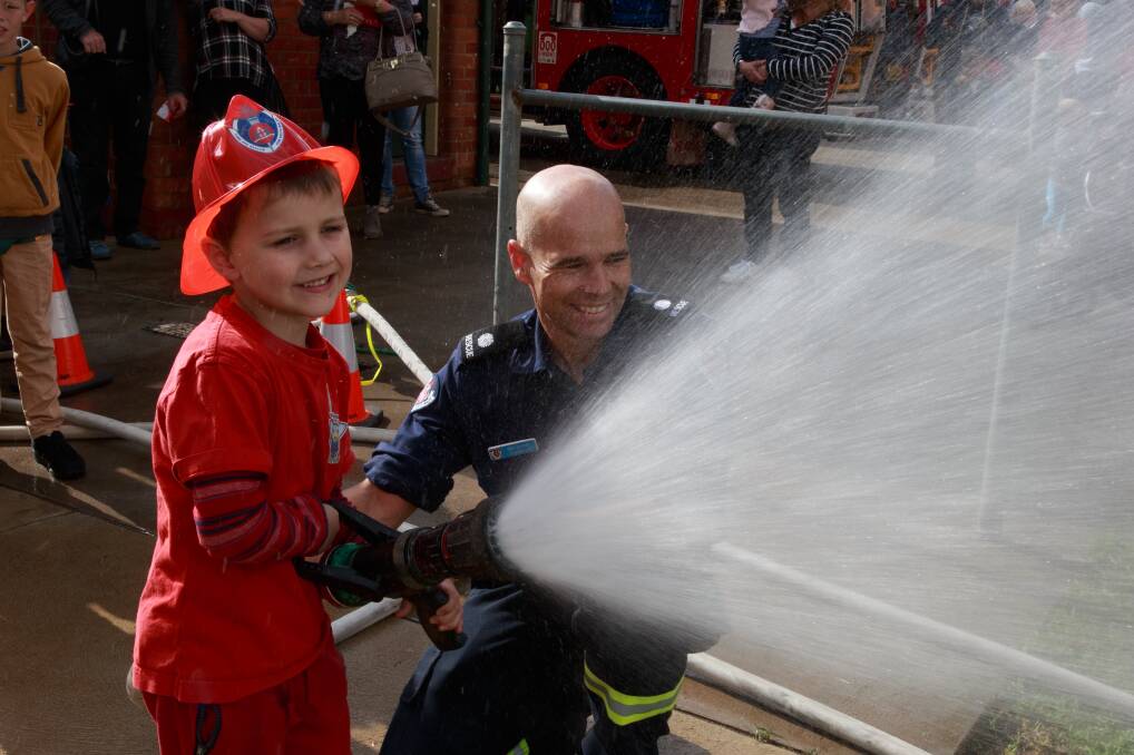 HOW TO BE A FIREFIGHTER: Children were excited to try out equipment during the open day at Albury Civic fire station on Saturday. Pictures: SIMON BAYLISS