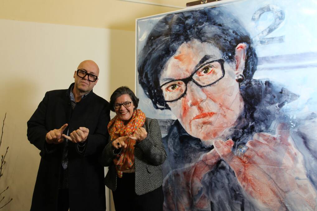 DETERMINED: Charles Sluga and Cathy McGowan with the Yackandandah artist's work on Monday evening. Pictures: SHANA MORGAN