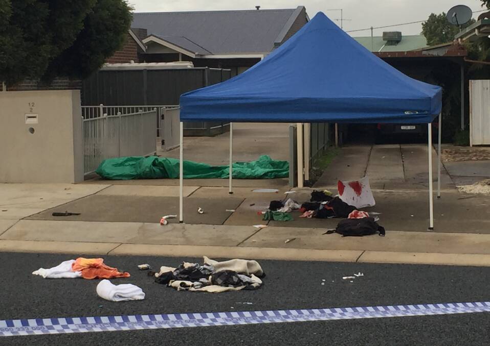HORROR SCENE: A bloodied pillow and clothing remained out the front of a White Street home in Wangaratta on Saturday in the aftermath of a brawl between armed men. Pictures: SHANA MORGAN