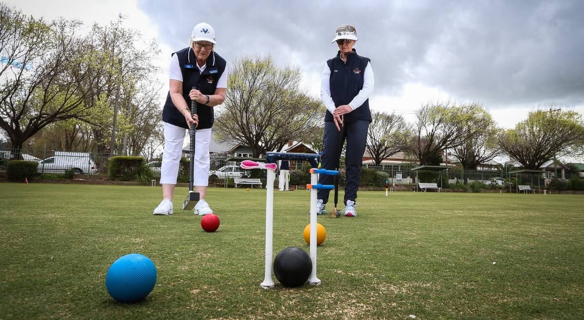 ON COURT: Albury Croquet Club's Helen Collins and Kaye Moffat play the course during the club's inaugural Golf Croquet tournament at the weekend. Picture: JAMES WILTSHIRE