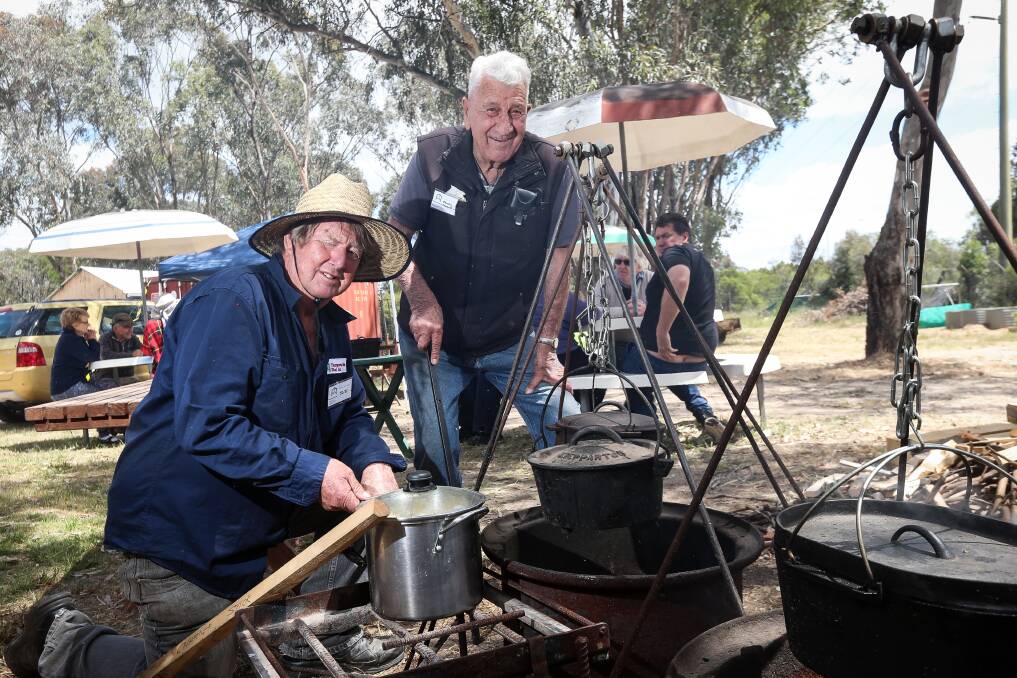 YES CHEF: Thurgoona Men's Shed members Ricky Taylor and Charley Cornell cook lunch in camp ovens for Saturday's family open day. Picture: ELENOR TEDENBORG