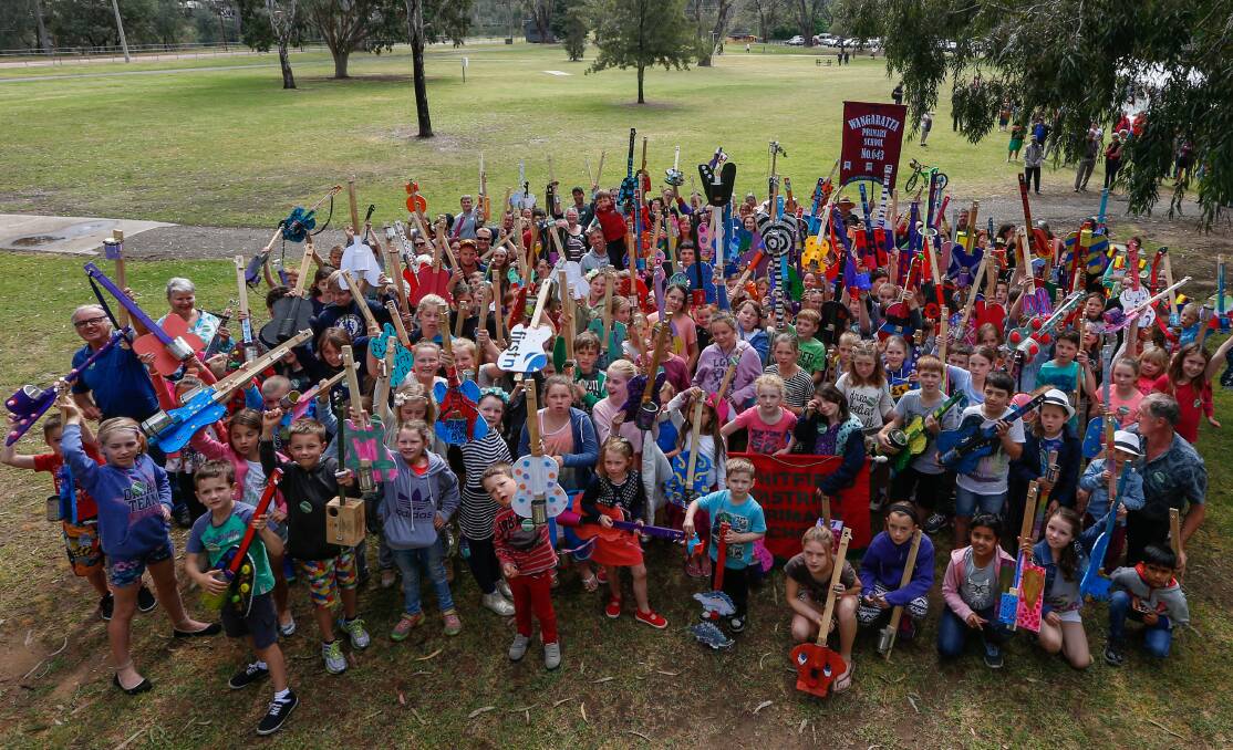 IN TUNE: Hundreds flocked to Wangaratta's Apex Park on Sunday for a diddley bow playing record attempt, which launched this year's jazz festival. Pictures: MARK JESSER