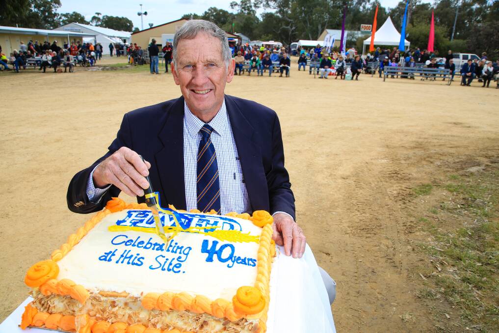 FARMING LEADER: Colin Wood, chairman of the Henty Machinery Field Days for three decades, cuts the 40th anniversary cake at the 2016 event.