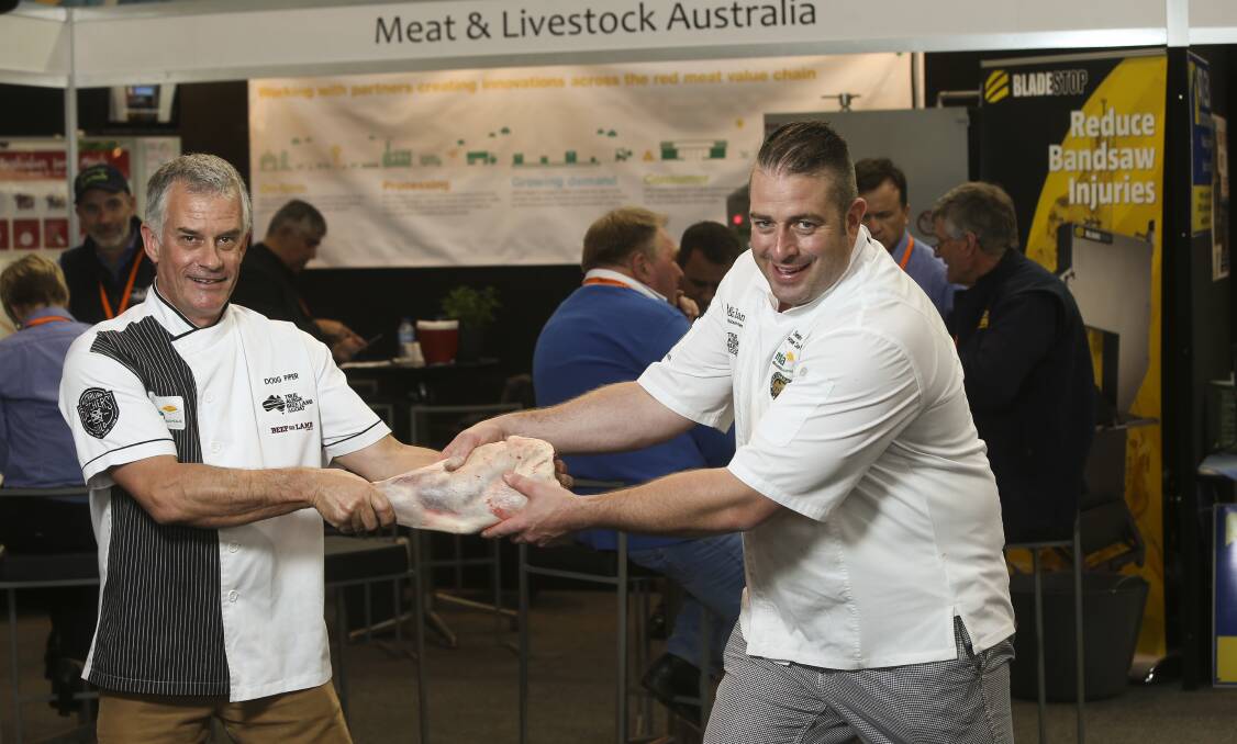 I'M PULLING YOUR LEG: Meat and Livestock butcher Doug Piper and chef Sam Burke "Lamb it up" for the camera after presenting their "big lamb small cuts" session at LambEx in Albury this week. Picture: ELENOR TEDENBORG