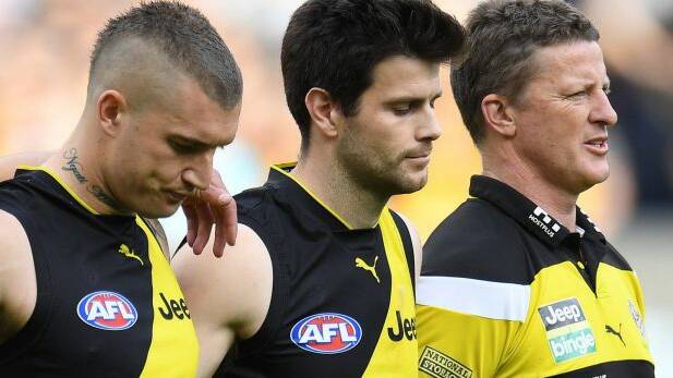 Richmond skipper Trent Cotchin with Dustin Martin and coach Damien Hardwick. Photo: AAP
