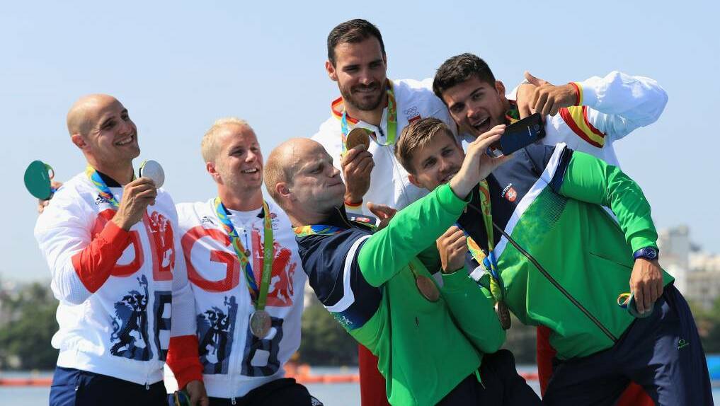 The medallists in the Men's Kayak Double take a selfie on the pdoium. Photo: Mike Ehrmann/Getty Images
