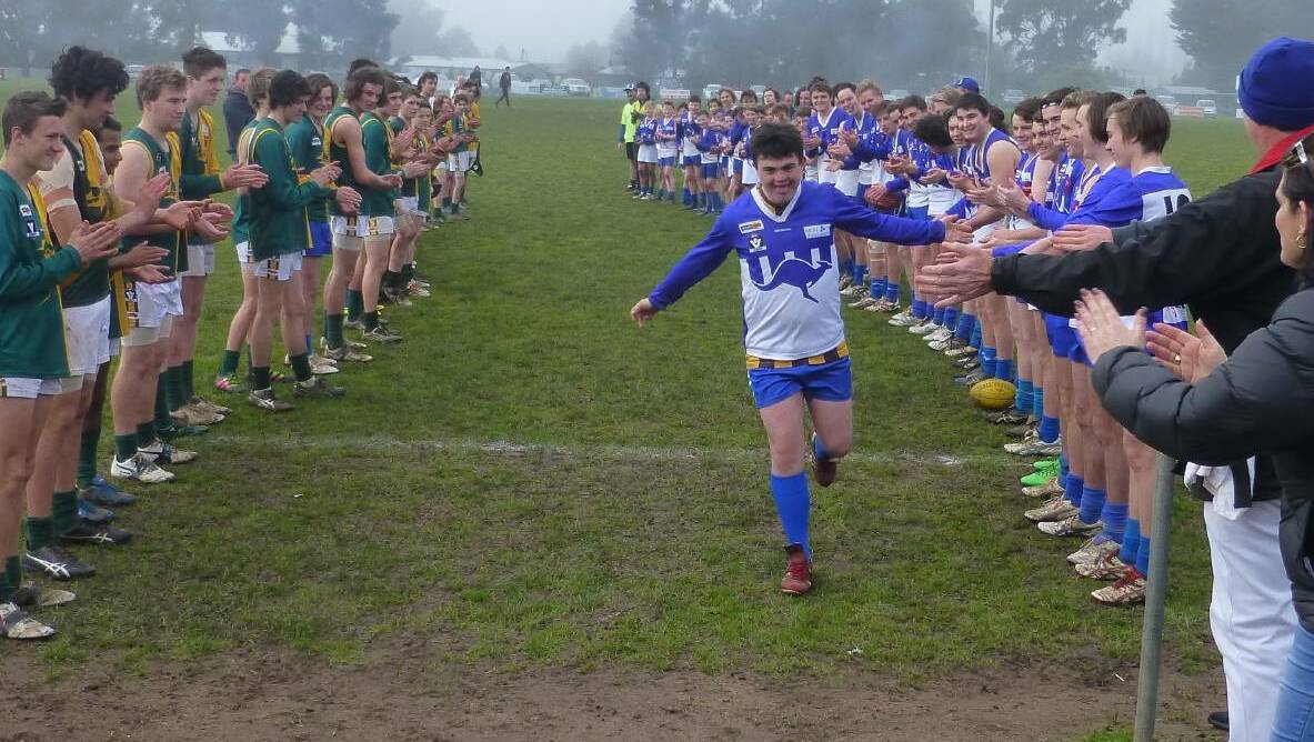 Gordon and Waubra players and supporters form a guard of honour for popular junior Jesse Cullinan to leave the ground, as a player, one last time.