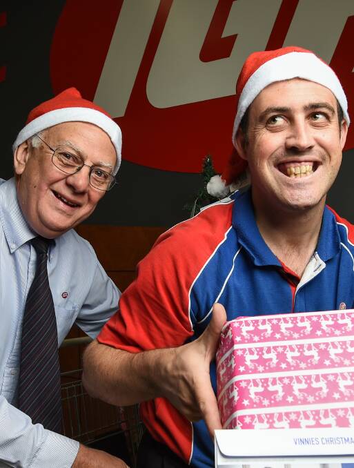 CHRISTMAS CHEER: Bob Mathews and Michael Mealor of East Albury's IGA have called on the community to dig deep for the needy this holiday season. Picture: MARK JESSER 