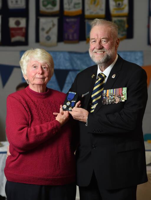 GONG: Hazel Rushby accepts the meritorious medal on behalf of her father, Noel Rushby, from RSL south west district president Alan Hutchings. Picture: MARK JESSER